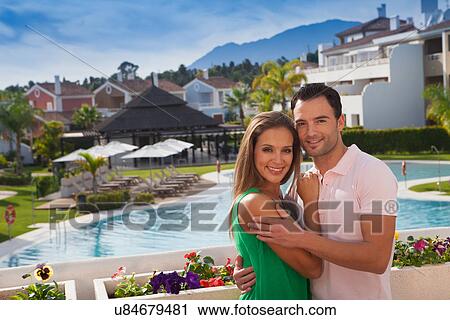 Young couple at holiday resort View Large Photo Image Stock Image - Young couple at holiday resort. Fotosearch