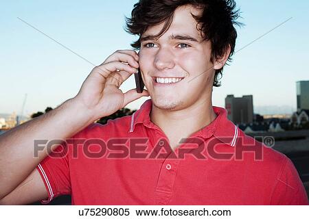 Young man on cellphone View Large Photo Image Stock Photography - Young man on cellphone. Fotosearch