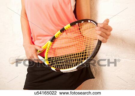 Young woman holding tennis racket View Large Photo Image Stock Image - Young woman holding tennis racket. Fotosearch