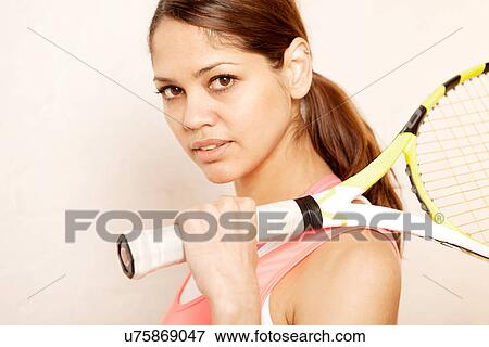 Young woman holding tennis racket View Large Photo Image Stock Photo - Young woman holding tennis racket. Fotosearch