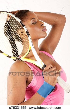 Young woman holding tennis racket View Large Photo Image Stock Photograph - Young woman holding tennis racket. Fotosearch