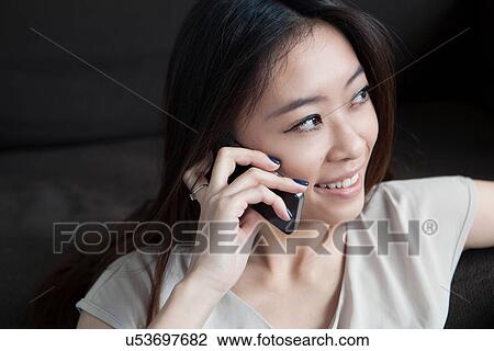 Young woman on cell phone View Large Photo Image Stock Image - Young woman on cell phone. Fotosearch