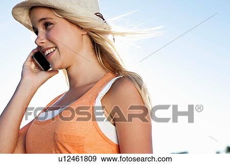 Stock Photo - Young woman on cellphone. Fotosearch