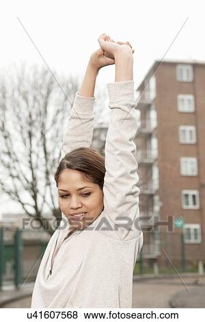Young woman stretching outdoors View Large Photo Image Stock Photo - Young woman stretching outdoors. Fotosearch
