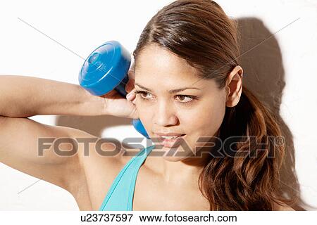 Young woman using hand weight View Large Photo Image Stock Photo - Young woman using hand weight. Fotosearch