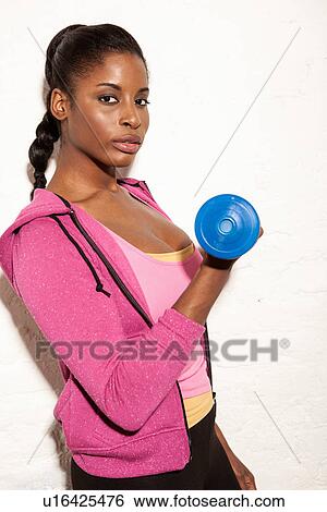Young woman using hand weight View Large Photo Image Stock Photograph - Young woman using hand weight. Fotosearch