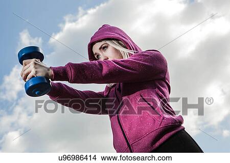 Young woman using hand weights View Large Photo Image Picture - Young woman using hand weights. Fotosearch