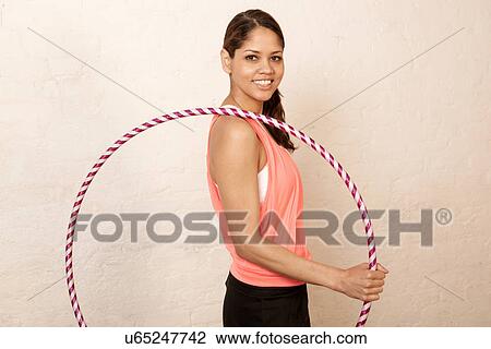 Young woman using plastic hoop View Large Photo Image Stock Image - Young woman using plastic hoop. Fotosearch