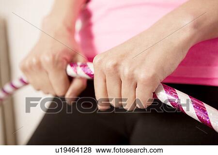 Young woman using plastic hoop View Large Photo Image Stock Photo - Young woman using plastic hoop. Fotosearch