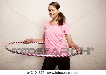 Young woman using plastic hoop View Large Photo Image Stock Photography - Young woman using plastic hoop. Fotosearch