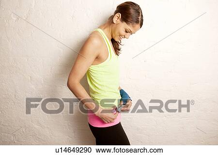 Young woman using stopwatch View Large Photo Image Stock Image - Young woman using stopwatch. Fotosearch