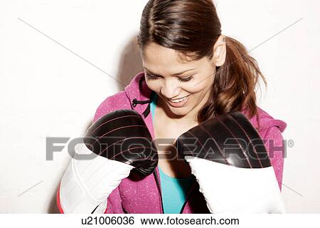 Young woman wearing boxing gloves View Large Photo Image Stock Photograph - Young woman wearing boxing gloves. Fotosearch