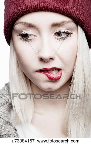 Young woman wearing red hat biting lip View Large Photo Image Stock Photo - Young woman wearing red hat biting lip. Fotosearch