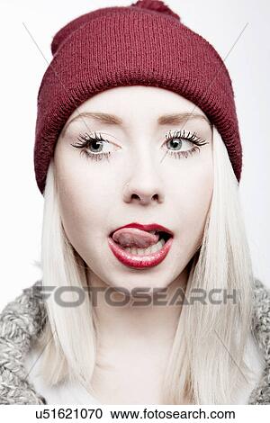 Young woman wearing red hat licking lips View Large Photo Image Stock Image - Young woman wearing red hat licking lips. Fotosearch
