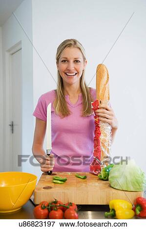 Young woman with baguette View Large Photo Image Stock Photo - Young woman with baguette. Fotosearch