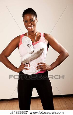 Young woman with trainers hanging around neck View Large Photo Image Stock Photo - Young woman with trainers hanging around neck. Fotosearch