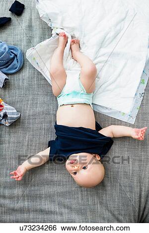 Baby boy wearing nappy, overhead view View Large Photo Image Stock Photograph - Baby boy wearing nappy, overhead view. Fotosearch