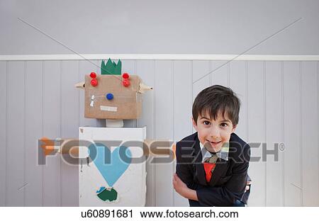 Boy leaning towards camera with homemade toy robot View Large Photo Image Stock Image - Boy leaning towards camera with homemade toy robot. Fotosearch
