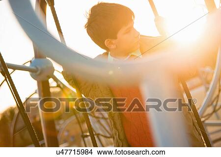 Picture - Boy on rope swing in playground. Fotosearch