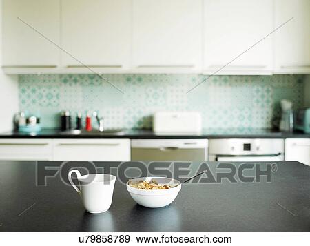 Stock Photo - Breakfast of tea and cereal on kitchen counter. Fotosearch