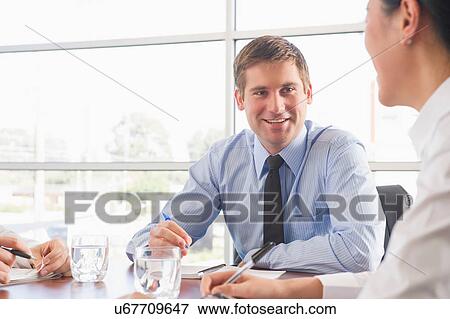 Business colleagues in office meeting View Large Photo Image Stock Photo - Business colleagues in office meeting. Fotosearch