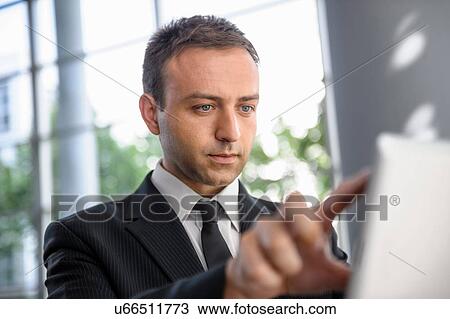 Businessman interacting with digital tablet screen View Large Photo Image Stock Image - Businessman interacting with digital tablet screen. Fotosearch
