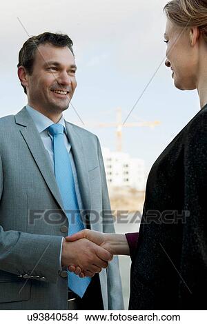 Businessman shaking hands in meeting outdoors View Large Photo Image Picture - Businessman shaking hands in meeting outdoors. Fotosearch