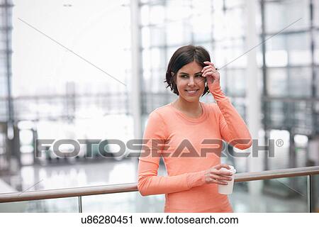 Stock Image - Candid portrait of young female with coffee. Fotosearch