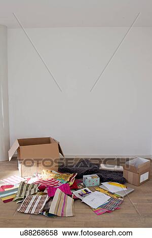 Stock Photo - Cardboard box and fabric samples on wooden floor. Fotosearch