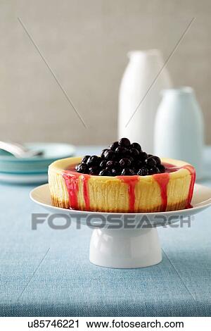 Stock Image - Cherry cheesecake and coulis. Fotosearch