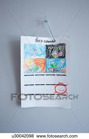 Stock Photo - Childhood drawings on calendar hanging on wall. Fotosearch
