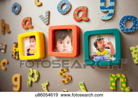 Stock Photo - Childhood photographs and picture on wall. Fotosearch