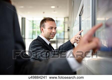 Close up of two businessmen interacting with touch screens View Large Photo Image Stock Image - Close up of two businessmen interacting with touch screens. Fotosearch
