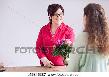 Customer buying bouquet from florist View Large Photo Image Stock Photo - Customer buying bouquet from florist. Fotosearch
