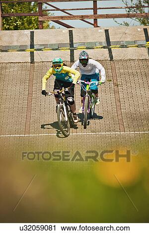 Cyclists riding on dirt bike course View Large Photo Image Stock Image - Cyclists riding on dirt bike course. Fotosearch