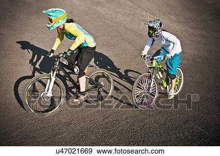 Cyclists riding on dirt bike course View Large Photo Image Stock Photo - Cyclists riding on dirt bike course. Fotosearch