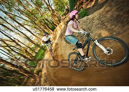 Cyclists riding on dirt bike course View Large Photo Image Stock Photo - Cyclists riding on dirt bike course. Fotosearch