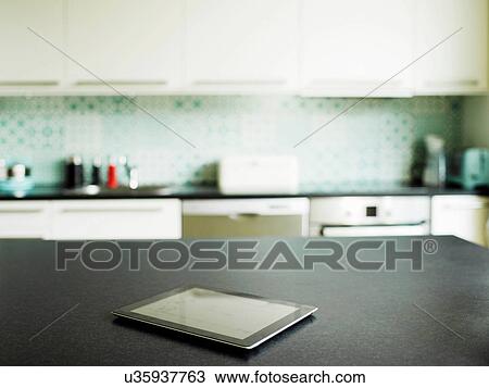 Stock Image - Digital tablet on kitchen counter. Fotosearch
