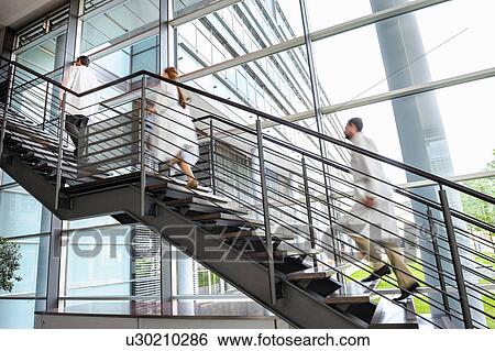 Stock Photograph - Doctors rushing up hospital staircase, blurred motion. Fotosearch