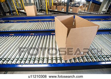 Stock Photo - Empty box on moving conveyor belt. Fotosearch