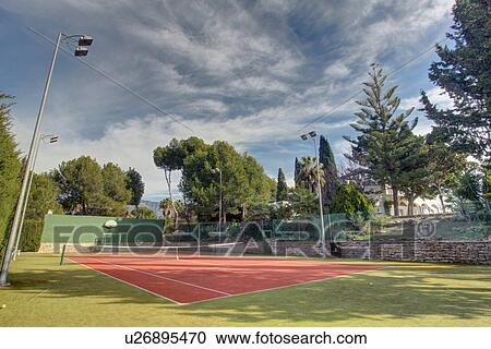 Empty tennis courts in grounds of luxury home View Large Photo Image Stock Image - Empty tennis courts in grounds of luxury home. Fotosearch