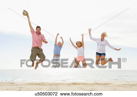 Family jumping on beach View Large Photo Image Stock Image - Family jumping on beach. Fotosearch