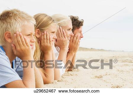 Family lying on beach, resting on elbows View Large Photo Image Stock Photo - Family lying on beach, resting on elbows. Fotosearch