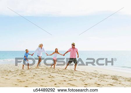 Family walking on beach holding hands View Large Photo Image Stock Image - Family walking on beach holding hands. Fotosearch