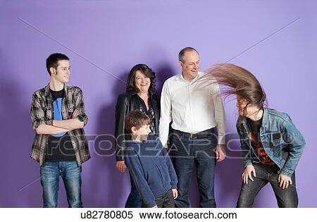 Family watching son headbang in front of purple background View Large Photo Image Stock Photography - Family watching son headbang in front of purple background. Fotosearch