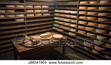 Fresh cheese wheels on table in cabin View Large Photo Image Picture - Fresh cheese wheels on table in cabin. Fotosearch