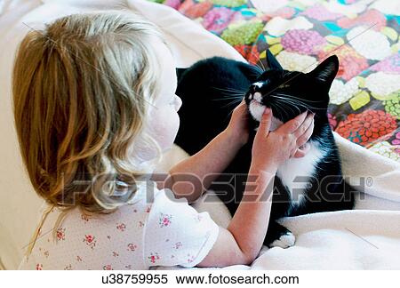 Girl stroking cat View Large Photo Image Stock Photography - Girl stroking cat. Fotosearch