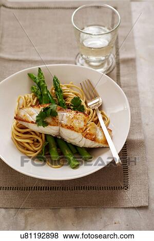 Stock Photo - Grilled fish, asparagus and linguine. Fotosearch