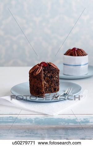 Stock Image - Individual fruitcake made with alcohol on plate. Fotosearch