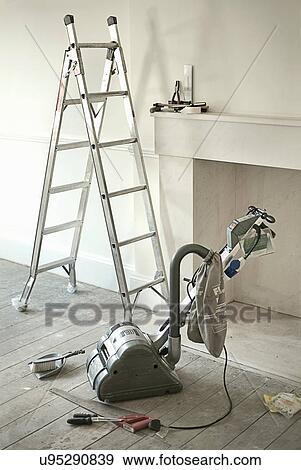 Ladders and sander by fireplace of new home View Large Photo Image Stock Photo - Ladders and sander by fireplace of new home. Fotosearch